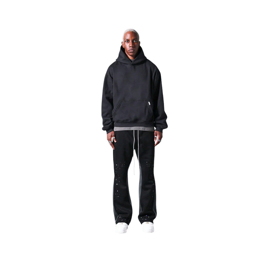 Pantaloni in Tuta Nera Flare di Cotone con schizzi di Vernice Uomo1