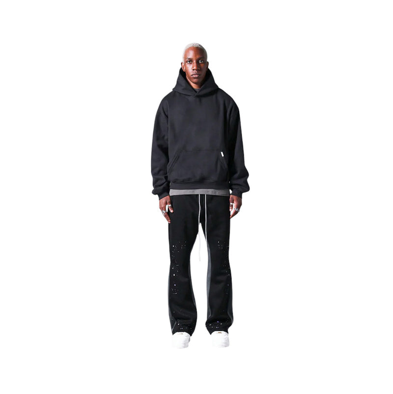 Pantaloni in Tuta Nera Flare di Cotone con schizzi di Vernice Uomo1